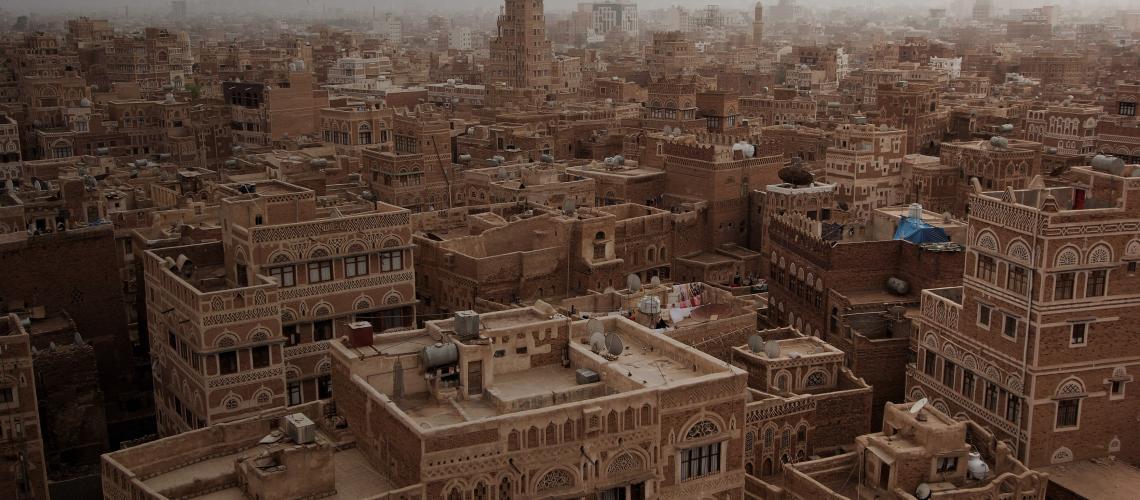 Yemen banner shows a bird's eye view of sprawling buildings in Old Sana'a. 