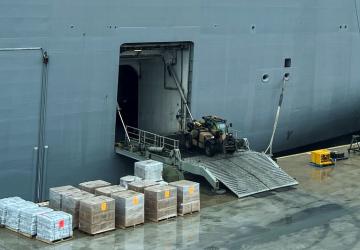 工人从船上卸载援助物资。