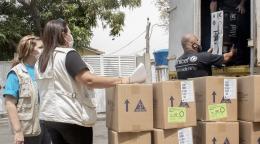 UN staff help unload humanitarian aid supplies to help in the response.