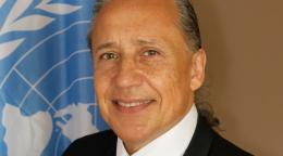 Official photo shows Gustavo González in front of the UN flag.
