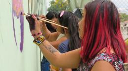 Women in Colombia decorate a wall with messages of peace in the town of Monterredondo.