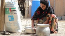 A woman makes bread using flour given to her as part of her monthly food ration from WFP. 