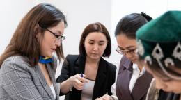 Four women at a training for consultants of Women's Entrepreneurship Development Centers.