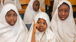 A group of school girls in white headscarves