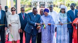 A photo of ten people in a line, the middle two of whom- the President of Senegal and the UN Deputy Chief- cut a ribbon with a pair of scissors.