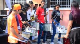 A popular youth group plays drums and music outside.