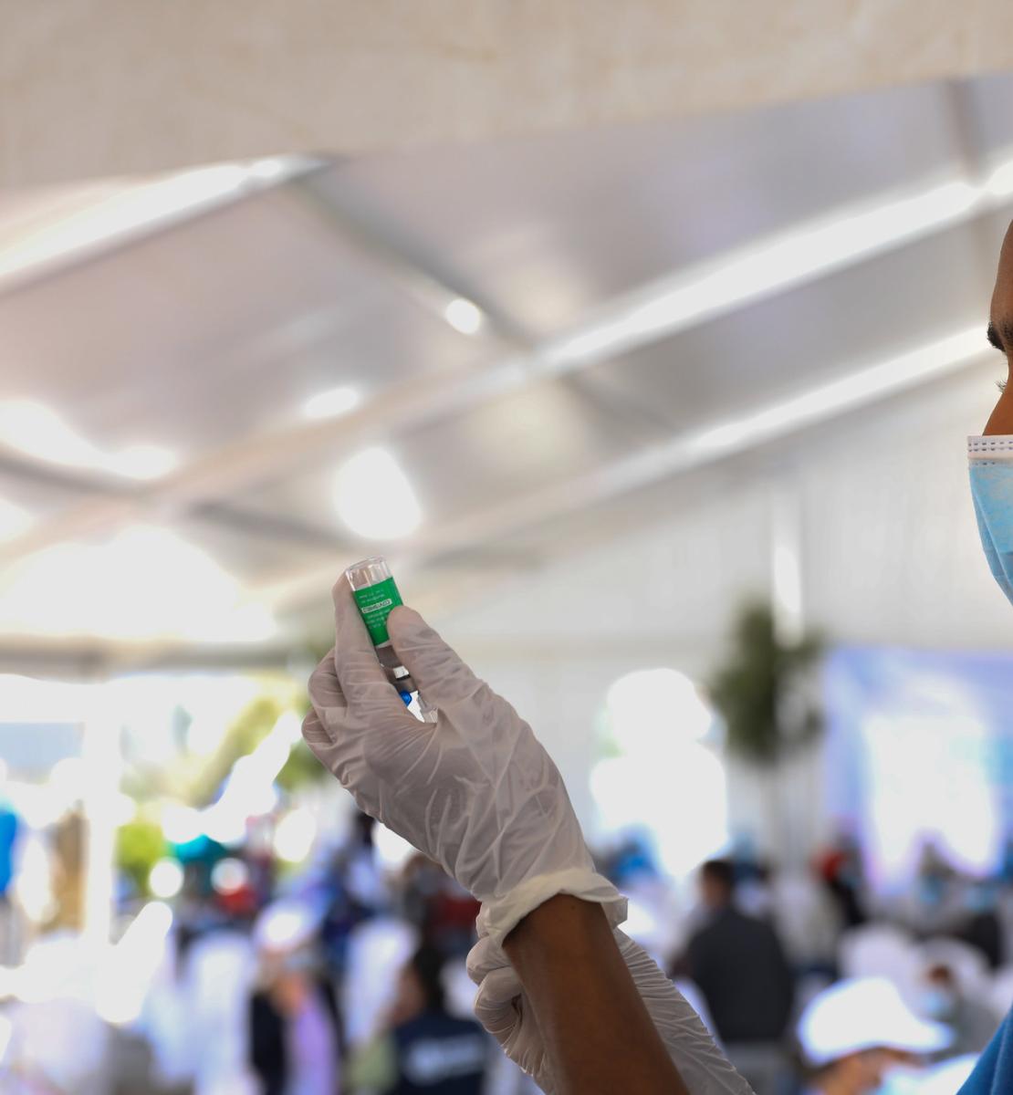 A healthcare worker from Eka Kotebe prepares a vaccine at the first COVAX vaccination rollout in Ethiopia.