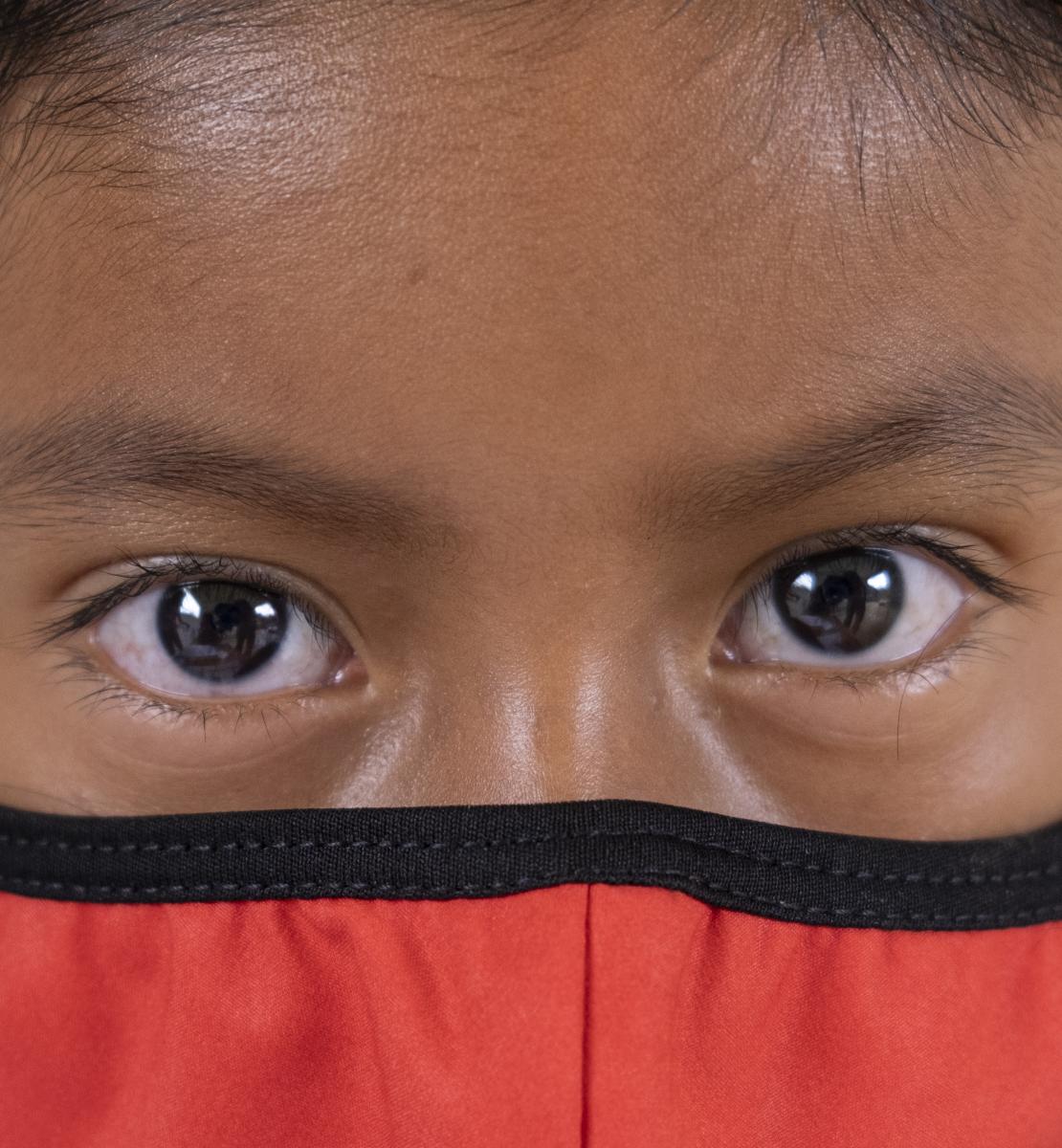A close up of a girl's face with a mask. 