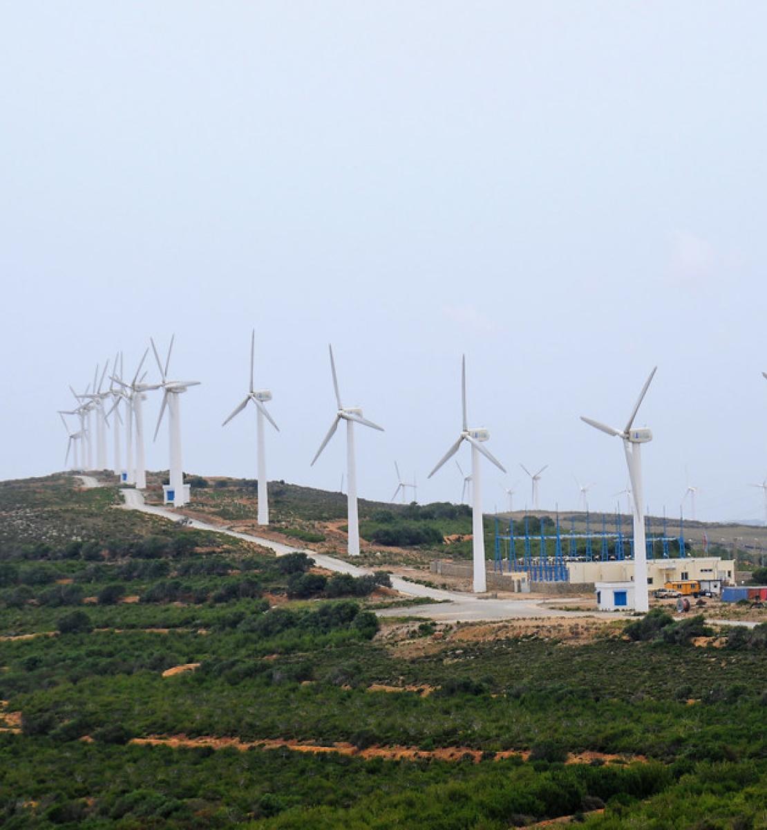 A wind turbine farm on a cloudy day. 