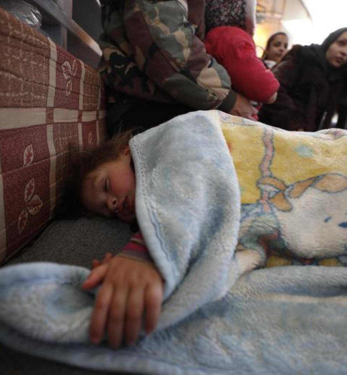 Child sleeping underneath a blanket in Aleppo