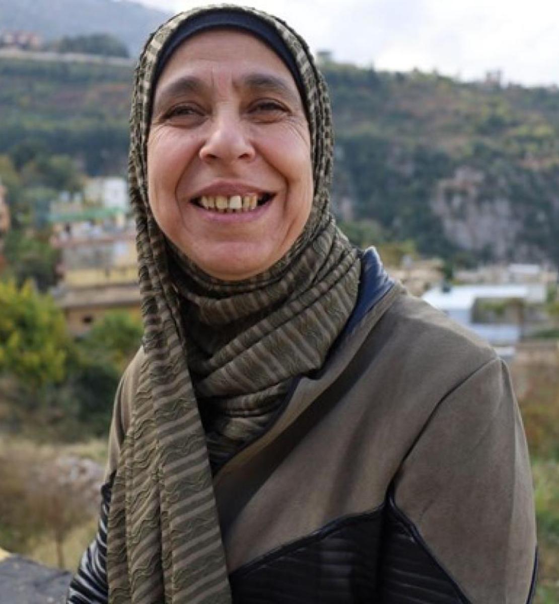 Woman in a headscarf smiling at the camera