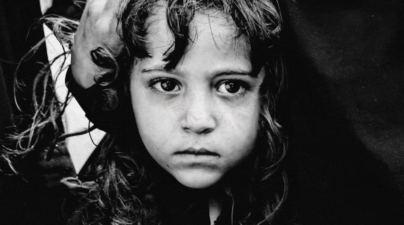Imagen de primer plano, en blanco y negro, de una pequeña niña yemení.