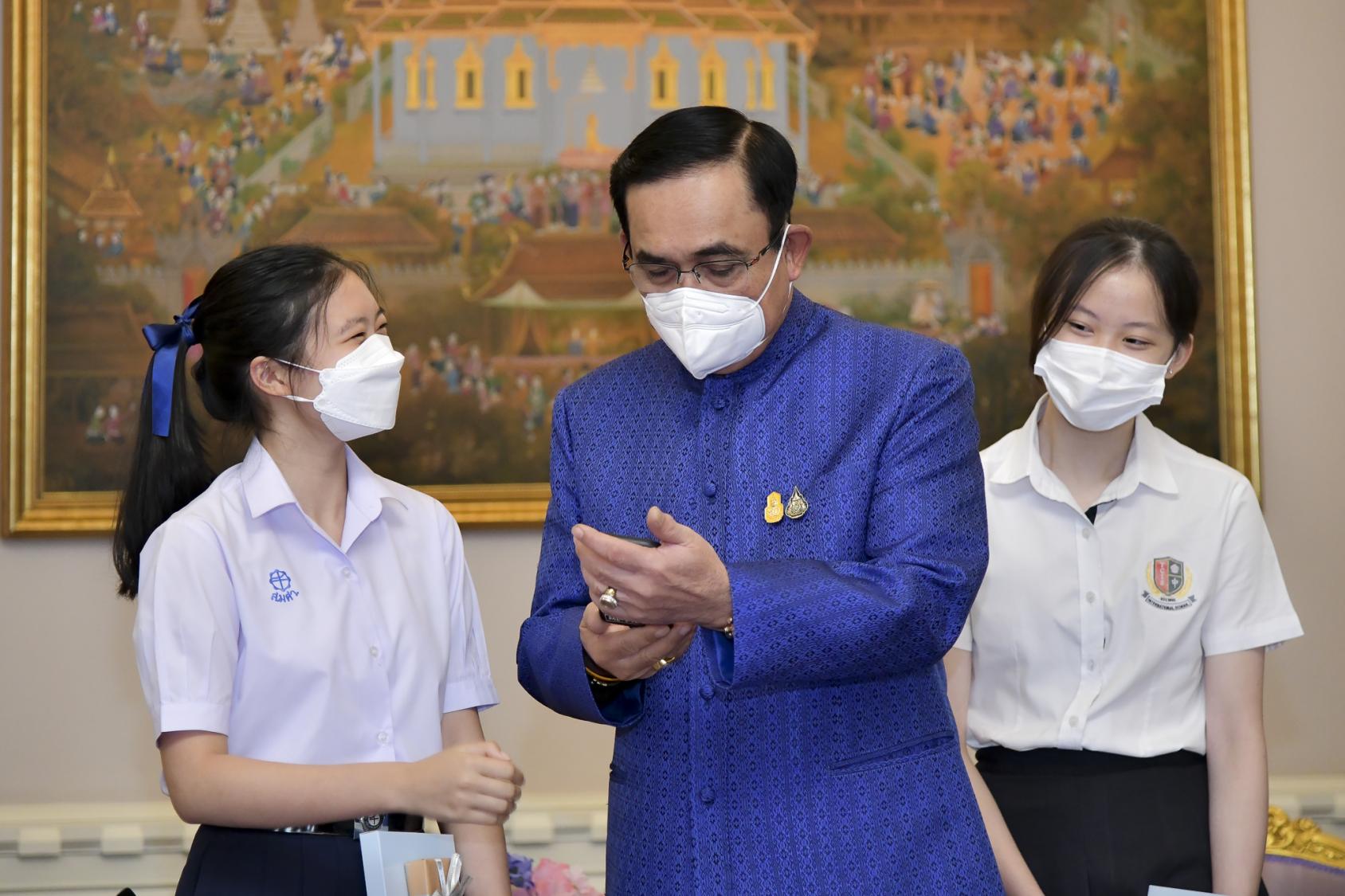 Thai youth climate leaders Aminta Permpoonwiwat, left, and Phatteeya Yongsanguanchai, meet with General Prayut Chan-o-cha, Prime Minister of Thailand, at the Government House.