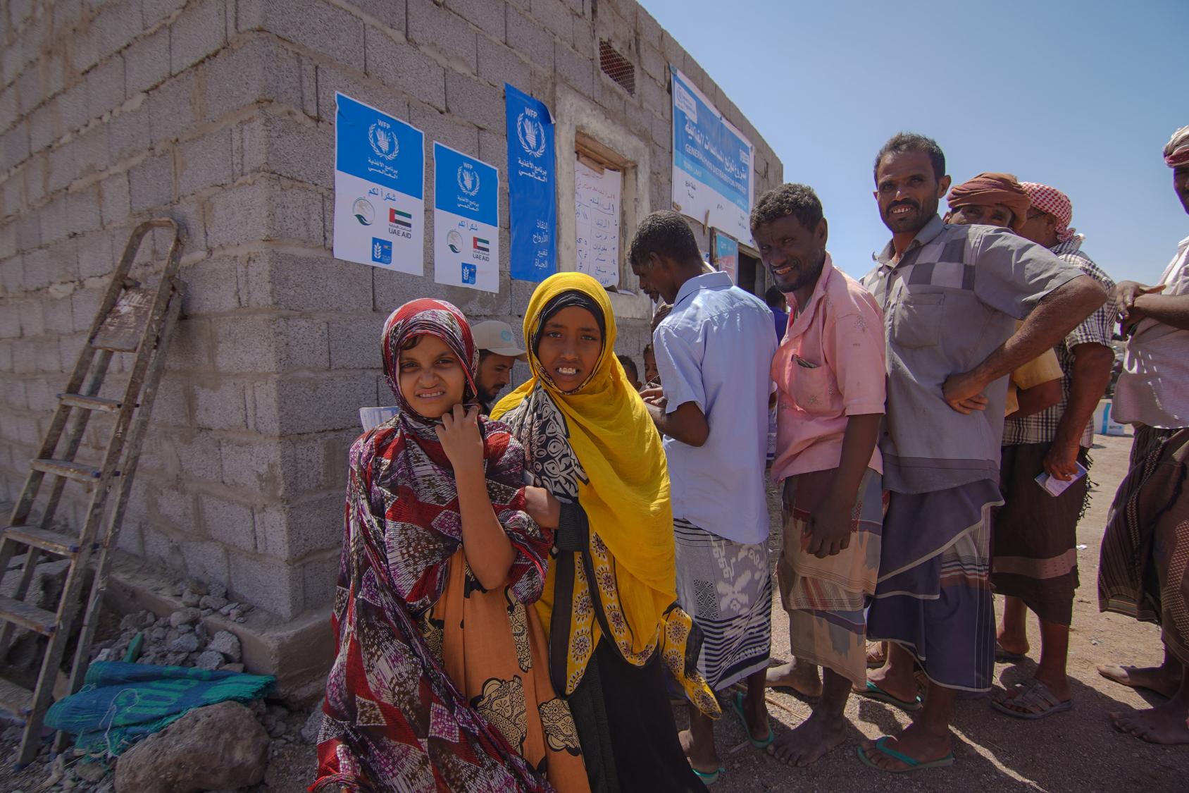 Des bénéficiaires récupèrent l'aide alimentaire qui leur est fournie par le PAM à Lahj, au Yémen. 