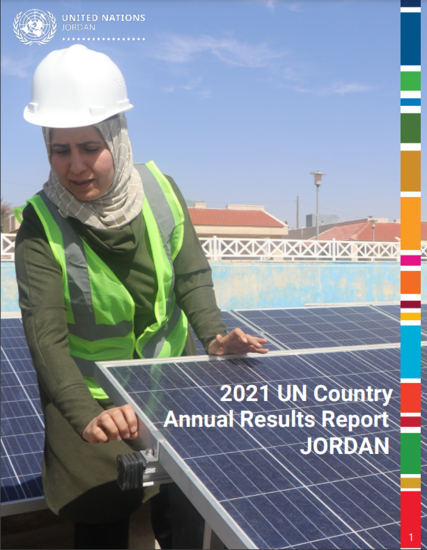 A woman with a white helmet over a head scarf and a bright vest adjusts solar panels on a roof on a sunny day.