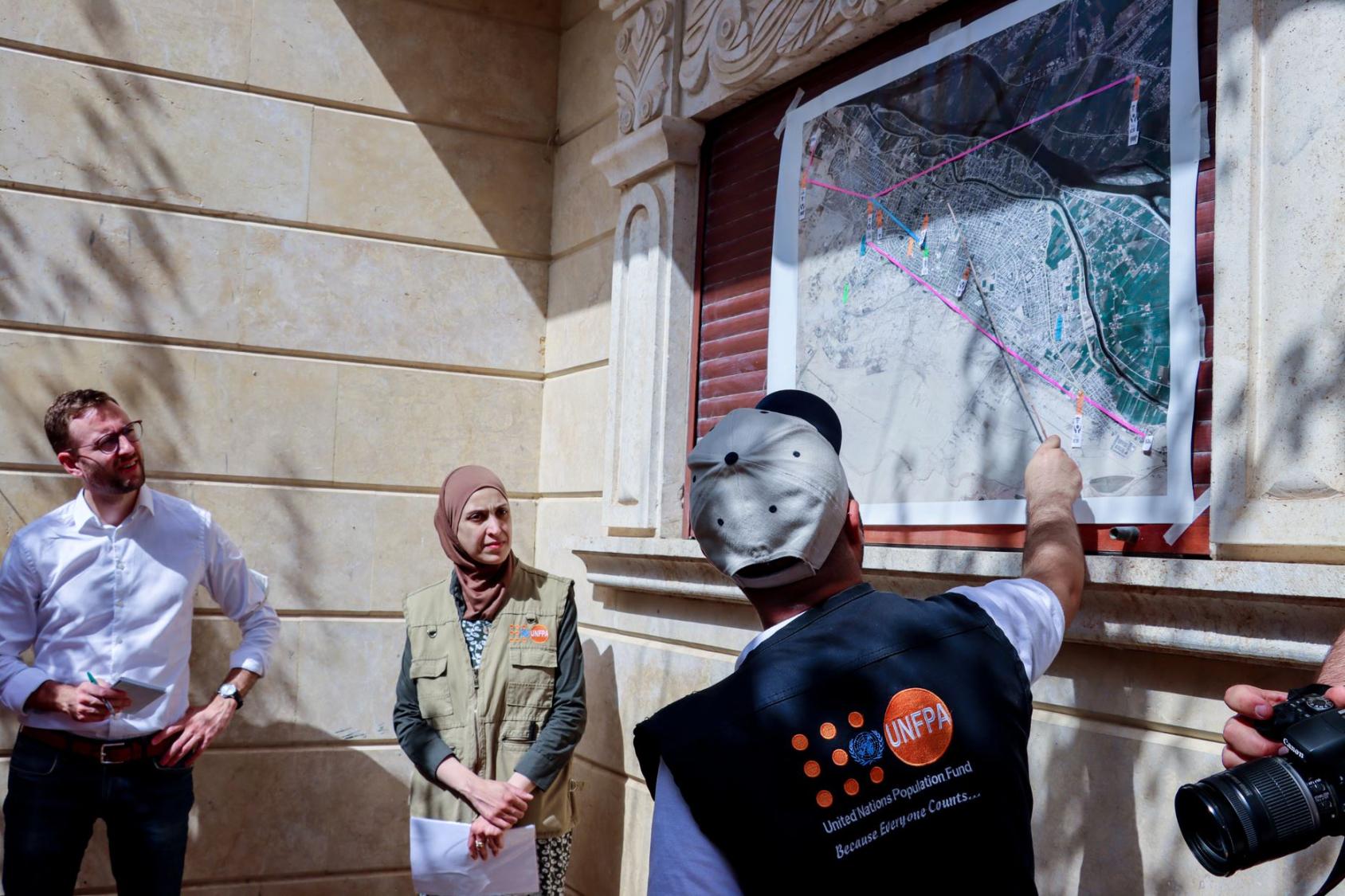 يقدم موظفون من صندوق الأمم المتحدة للسكان إحاطة لمجموعة من المانحين خلال زيارة لمدينة دير الزور.