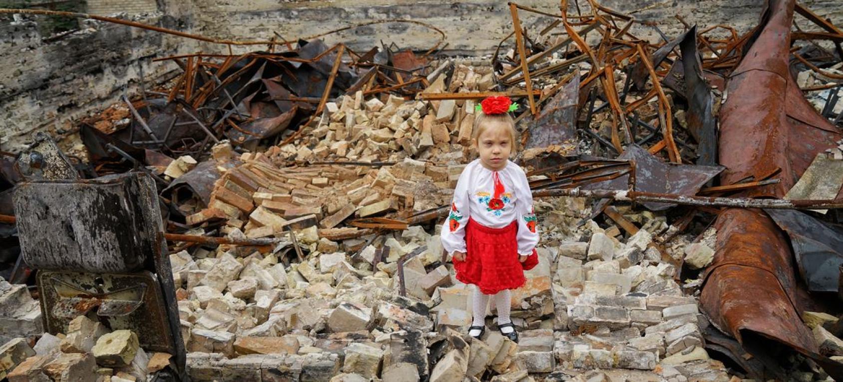 فتاة صغيرة تقف بين أنقاض مدرستها المدمرة في هورينكا بمنطقة كييف بأوكرانيا.