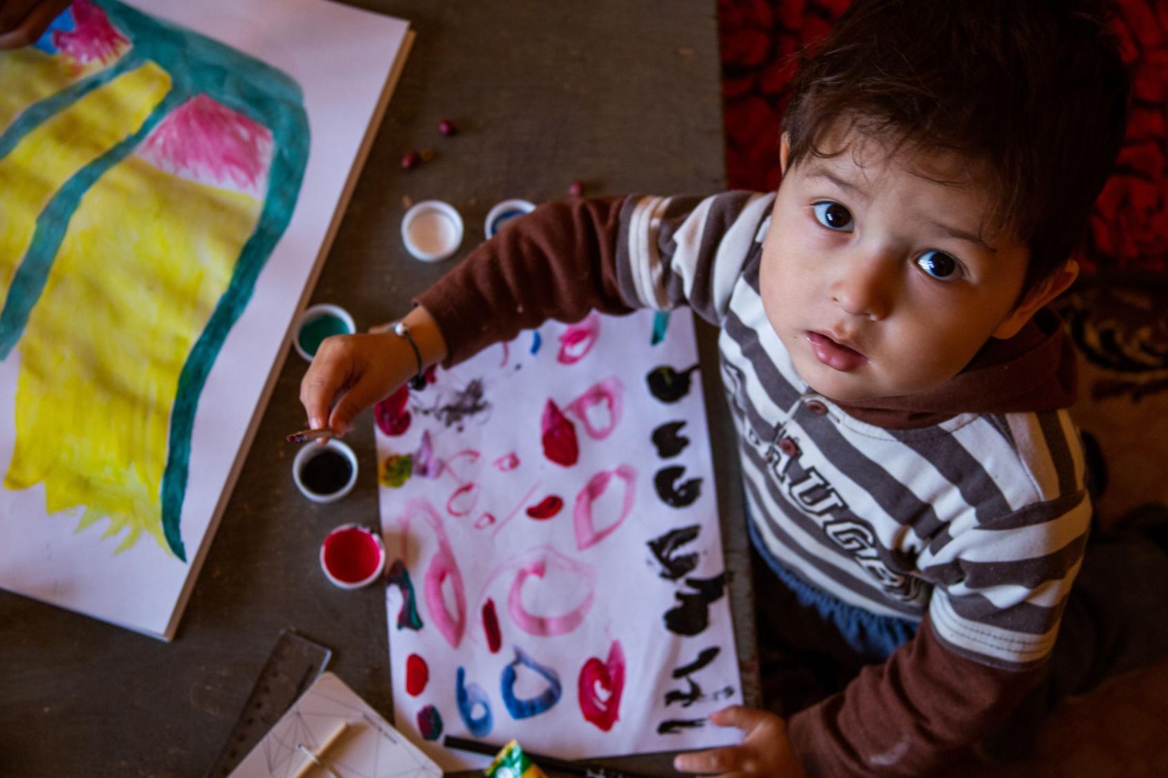 A child drawing with watercolors. 