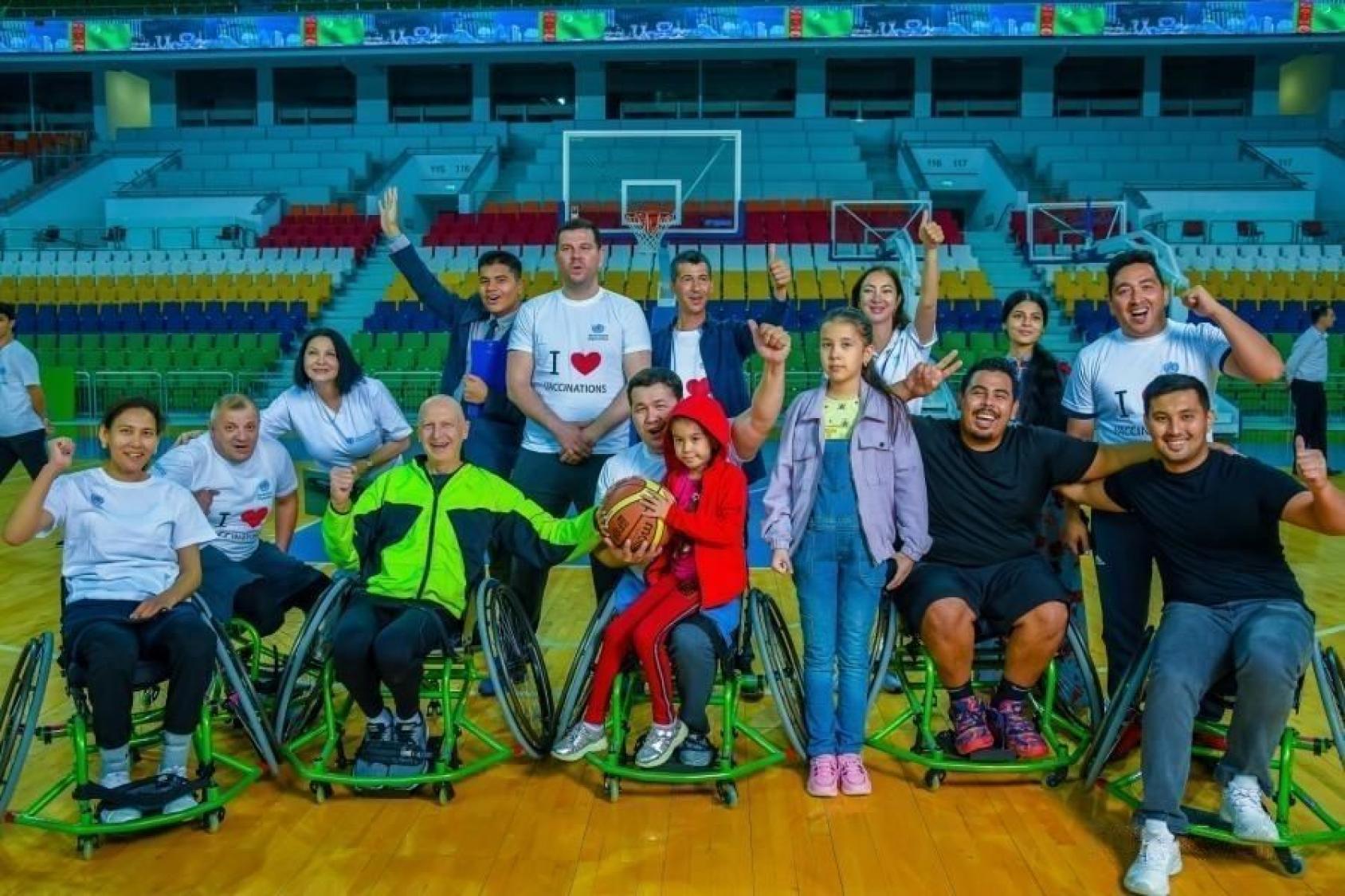 A group of para athletes are posing for a camera. 