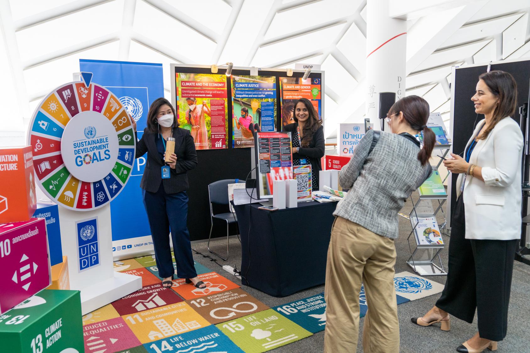 People standing in front of an exhibit of the sustainable development goals