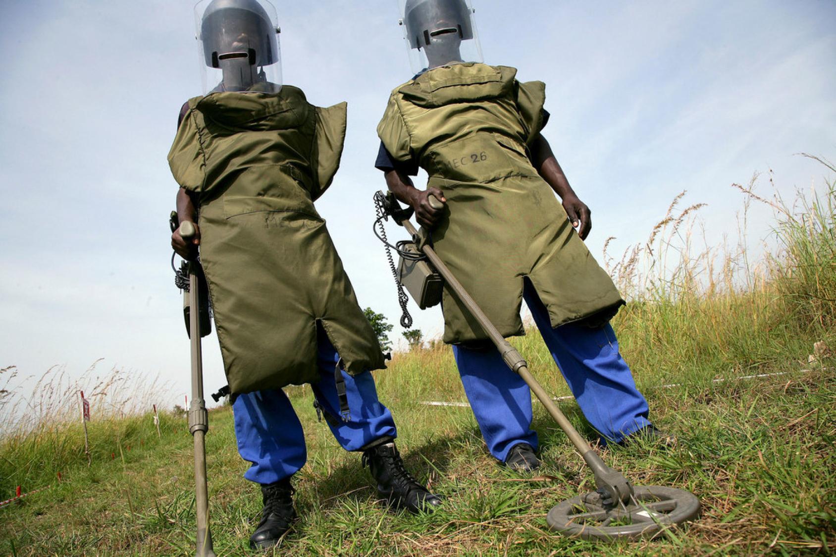 在刚果民主共和国布尼亚，两名排雷人员正在对土地进行排雷工作。