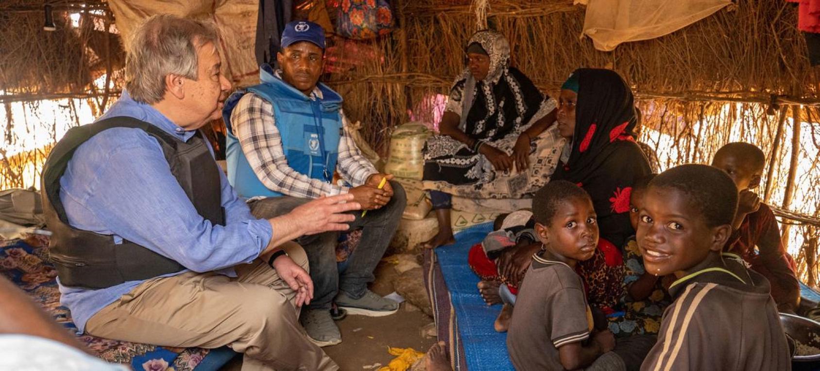 The UN Secretary General meets with a family and children in Somalia in a small makeshift tent