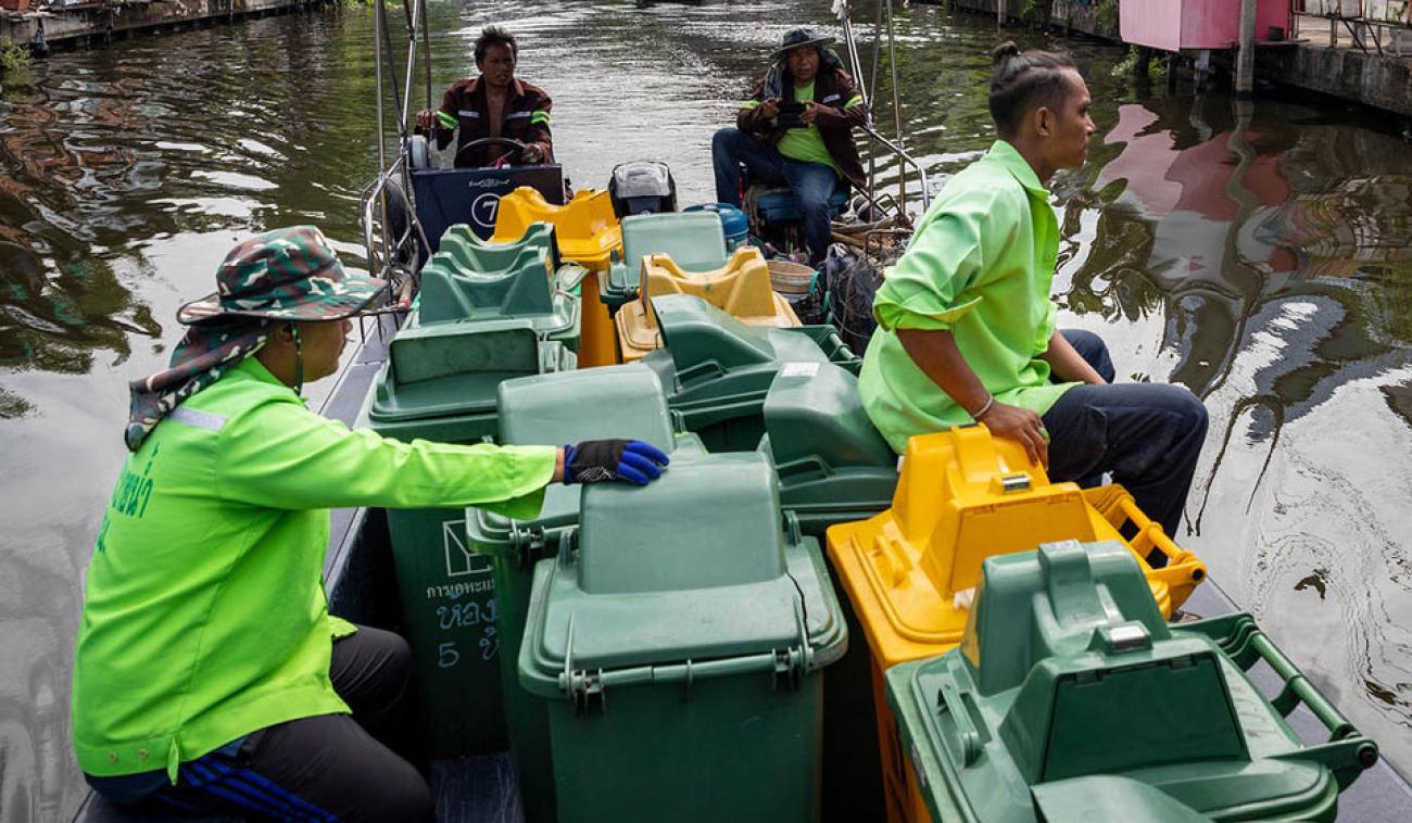 يجمع عمال الصرف الصحي النفايات البلاستيكية من القنوات في بانكوك، عاصمة تايلاند.