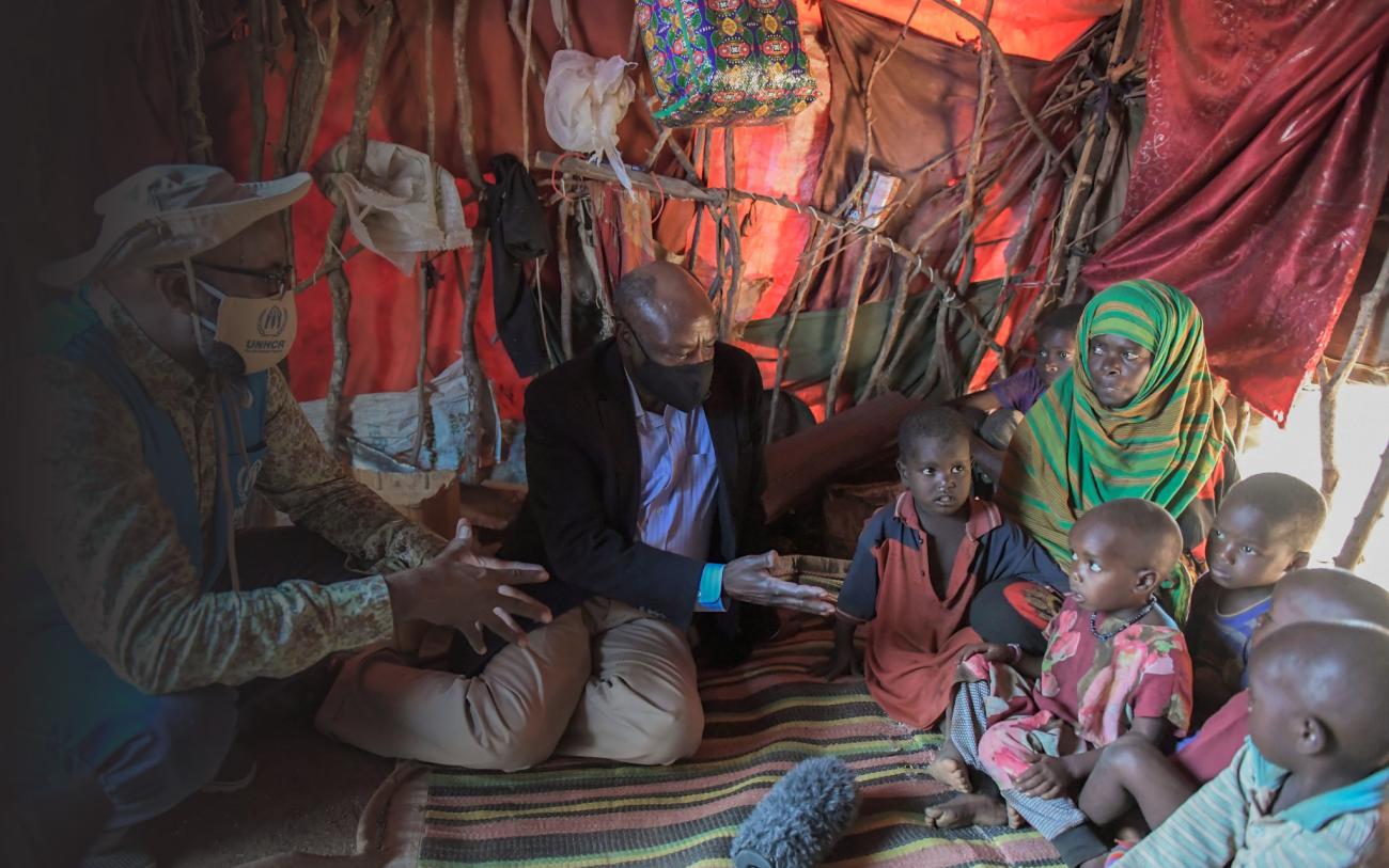 يتحدث نائب الممثل الخاص للأمين العام للأمم المتحدة في الصومال ومنسق الأمم المتحدة المقيم ومنسق الشؤون الإنسانية في الصومال آدم عبد المولى إلى فادومو عبدو حسن، امرأة نازحة حامل تعيش مع أطفالها الستة داخل منزلها الموقت في مخيم هاتافو للنازحين في بيدوا، جنوب غربي الصومال