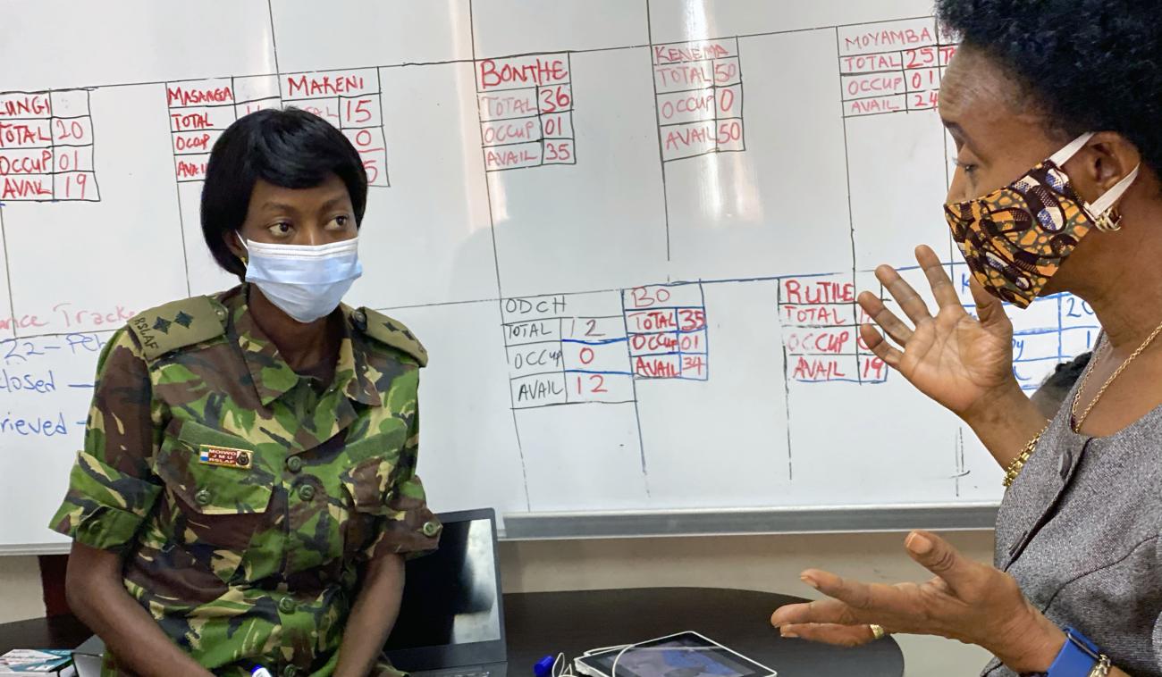 Lt. Moiwo and her colleague discuss the case management dashboard.