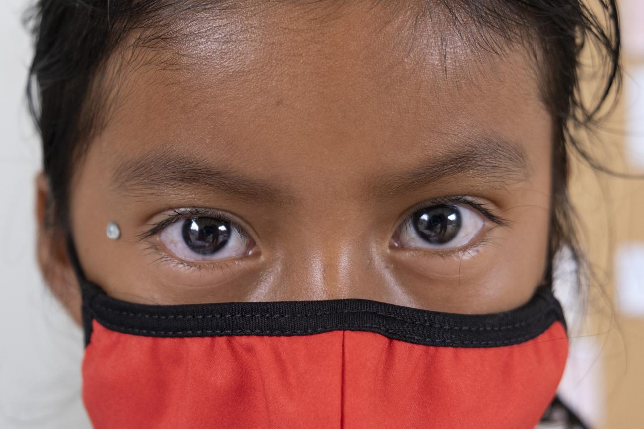 A close up of a girl's face with a mask. 
