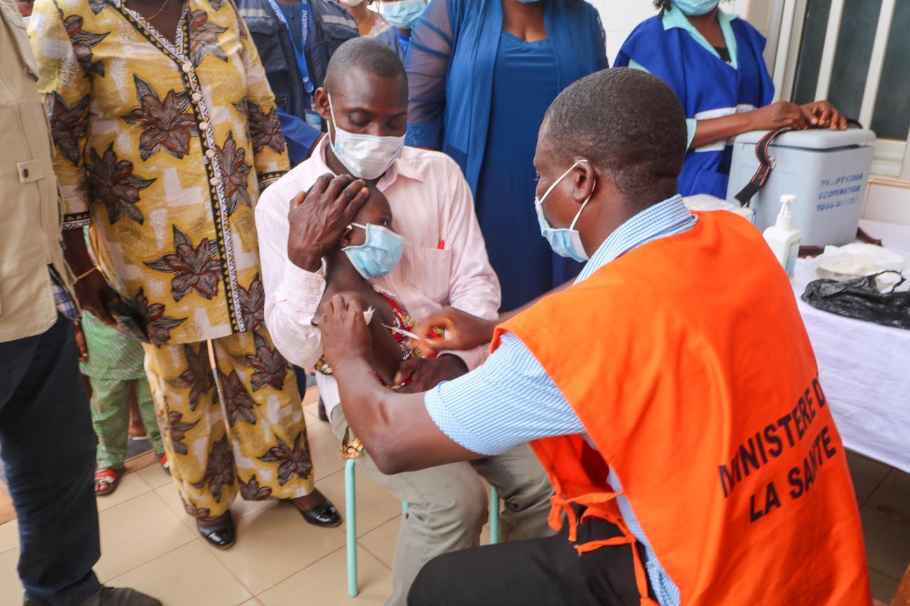 A health care worker from the Ministry of Health administers the polio vaccine to a child in Vogan, Togo, in February 2022