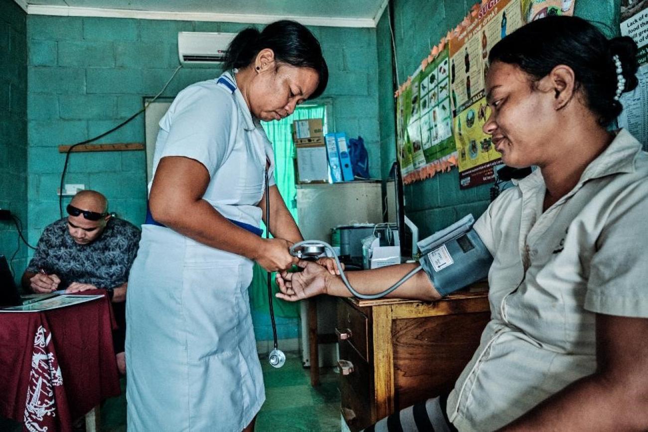 A nurse takes the blood pressure of a patient 