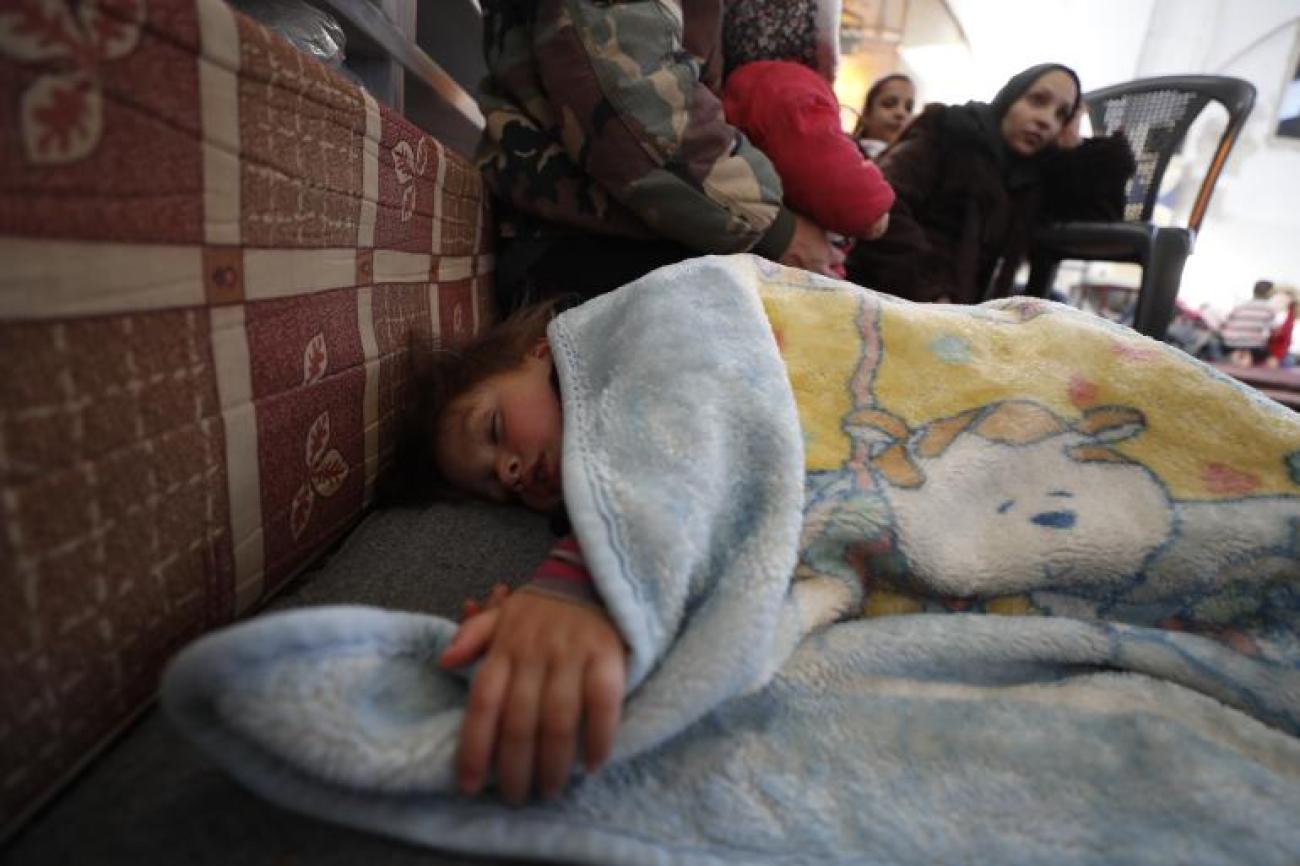 Child sleeping underneath a blanket in Aleppo
