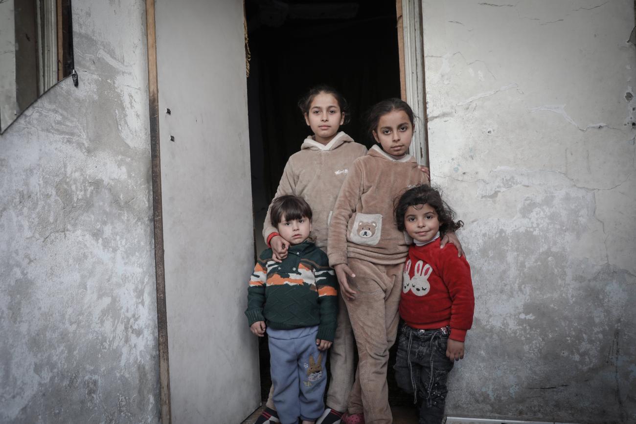 Four children in Syria standing at a doorway