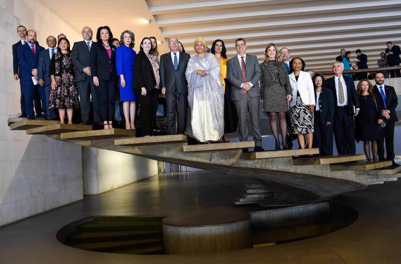 A group of people stand on a cascading staircase in Brasilia