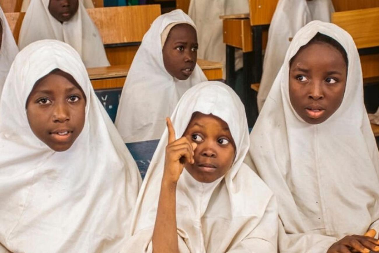 A group of school girls in white headscarves