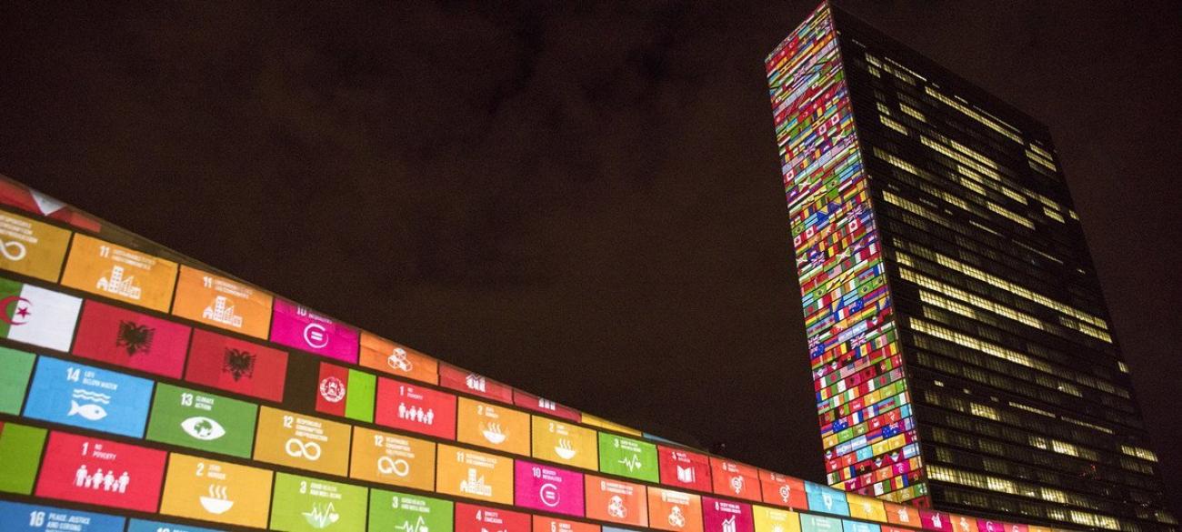 A colourful projection of the UN sustainable development goals appearing on the walls and the sides of the UN Headquarters building in New York