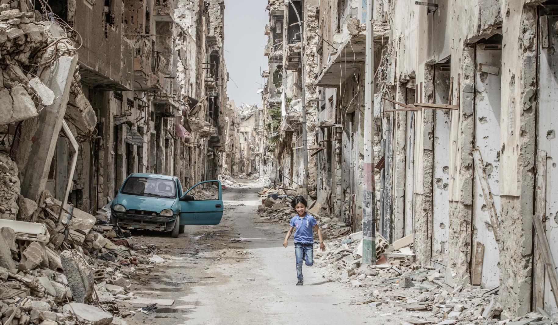 A child runs through the debris and wreckage in downtown Benghazi, Libya.