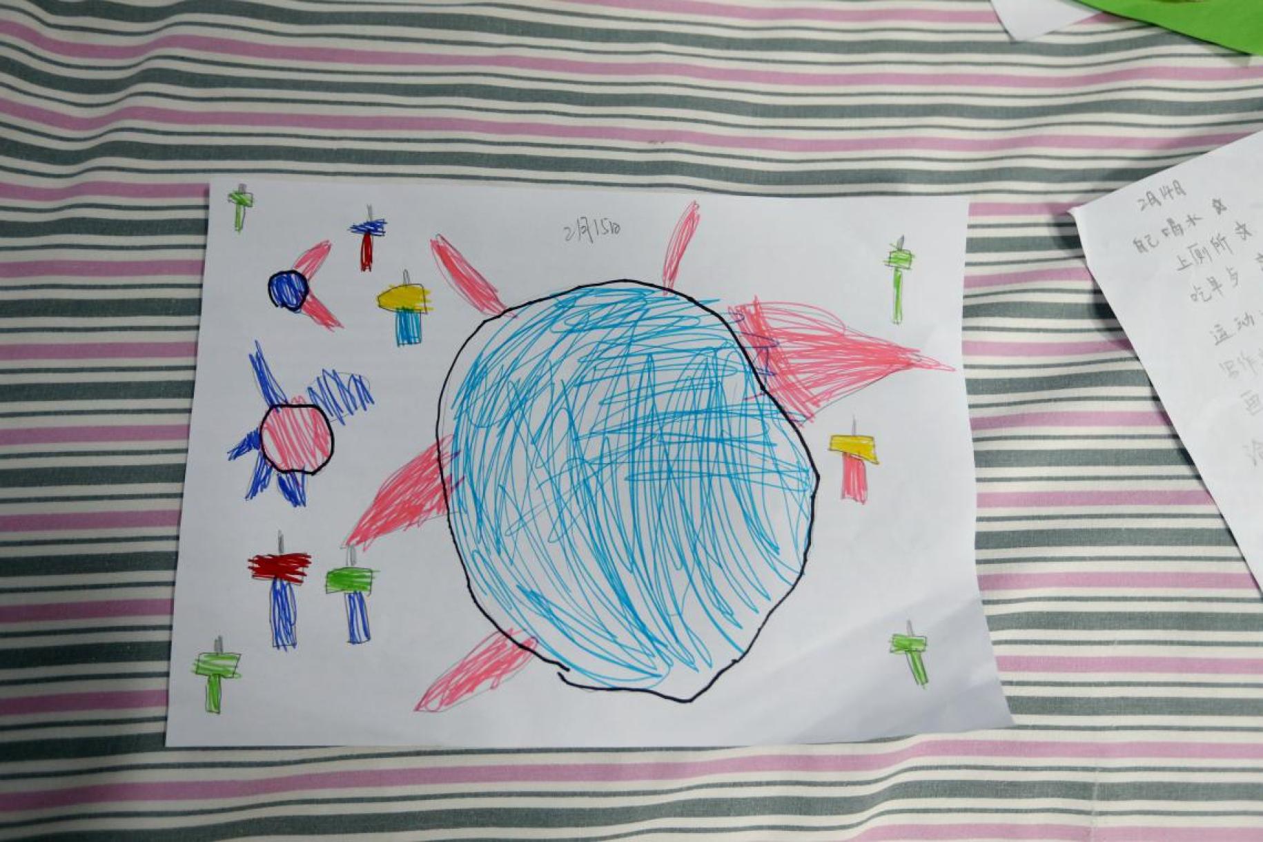 Child's drawing of the coronavirus surrounded by hammers.