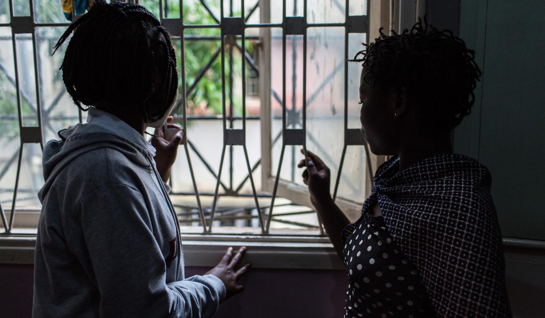 Dos supervivientes de la violencia miran por la ventana de las oficinas de una organización no gubernamental en Nampula.