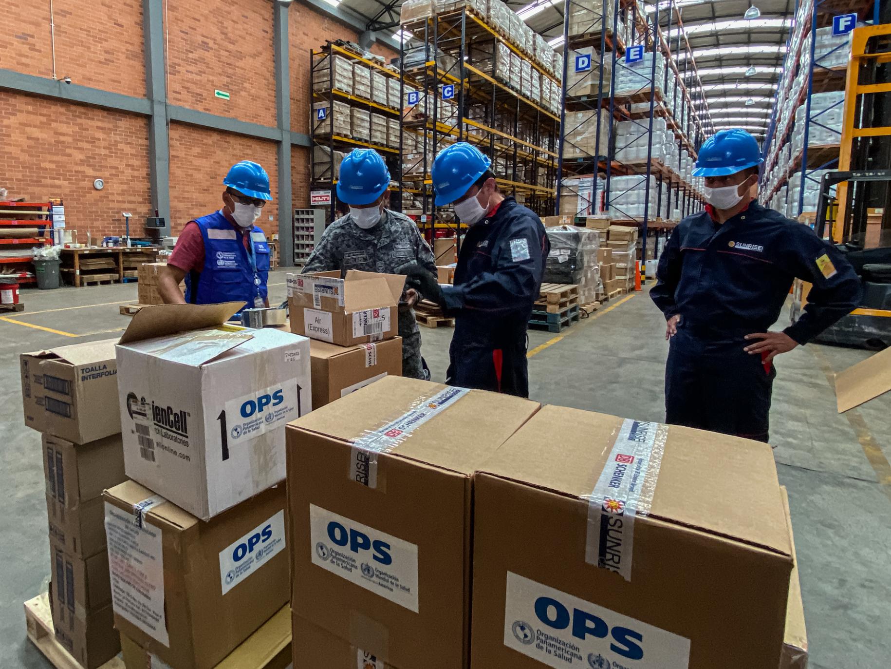 UN staffers at a warehouse stocked full of life-saving supplies.