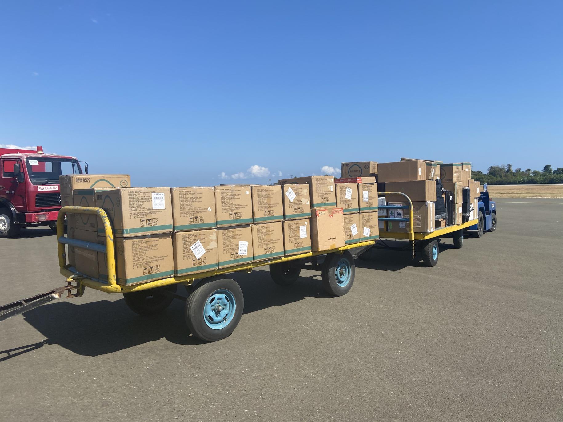 A cart pulls two loads of boxes with lifesaving essentials donated by WFP.
