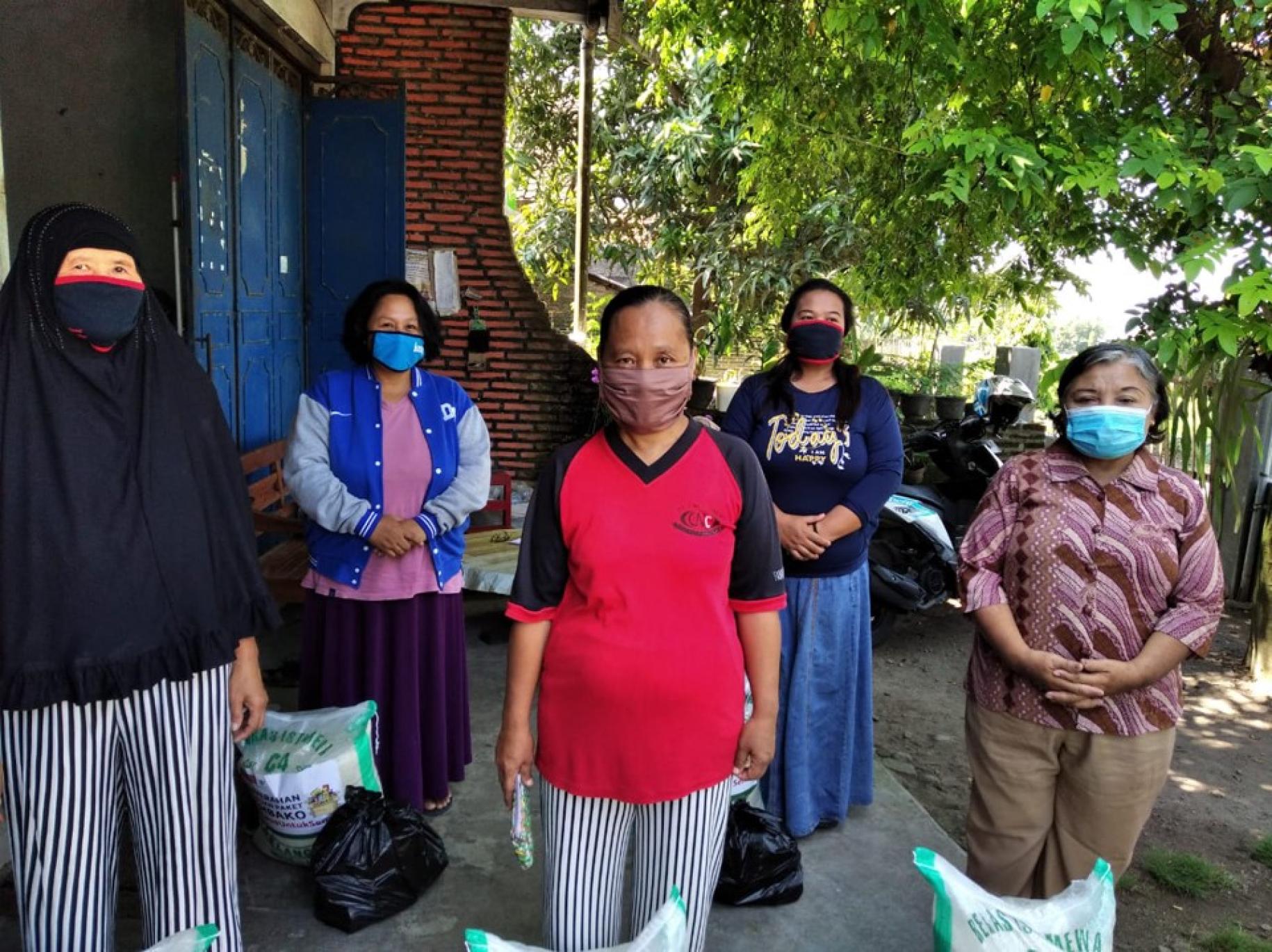 Women standing proud with their protective masks at Peace Village in Jetis, Central Java. 