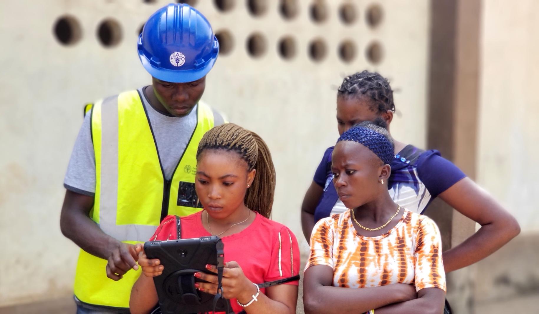 Young women are trained as para-surveyors to map family and village land boundaries. (Please note image was taken prior to COVID-19 social distancing measures were in place.