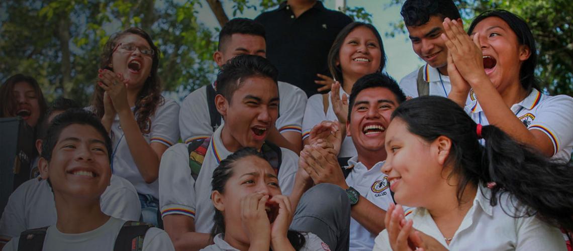 El Salvador banner shows youth laughing together.